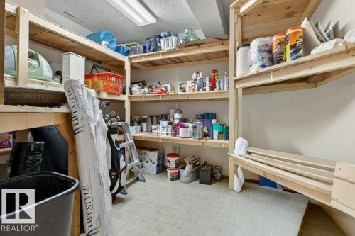 Dedicated storage space with extensive wooden shelving and tiled flooring - 2655 89 Street, Edmonton, AB - Indoor With Storage