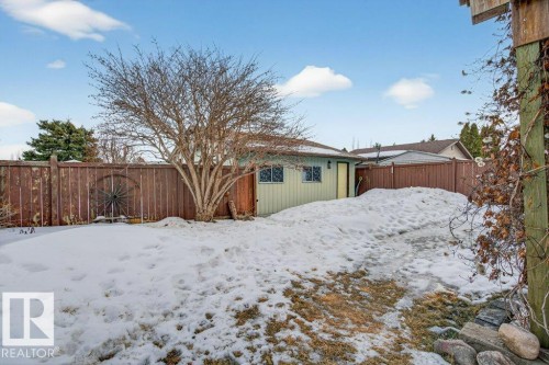 The property features an extensive yard with a wooden fence and a detached shed - 2655 89 Street, Edmonton, AB - Outdoor