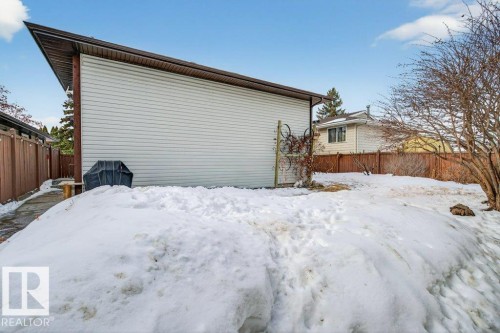 The property features a spacious yard with a paved walkway and fencing - 2655 89 Street, Edmonton, AB - Outdoor