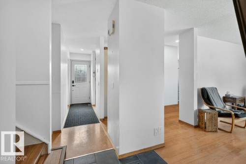 The property features a bright entryway with a white door, decorative glass, and a dark floor mat - 2655 89 Street, Edmonton, AB - Indoor Photo Showing Other Room