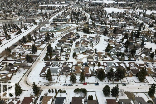 Aerial view of the surrounding neighborhood, featuring numerous residential properties with snow-covered roofs and mature evergreen trees - 2655 89 Street, Edmonton, AB - Outdoor With View