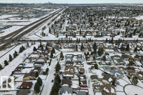 This aerial view showcases a residential area with a significant number of detached properties, each featuring individual roofs - 2655 89 Street, Edmonton, AB - Outdoor With View