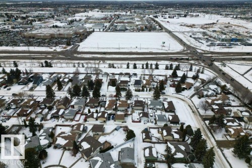 Aerial view showcasing a residential area with snow-covered roofs and mature trees - 2655 89 Street, Edmonton, AB - Outdoor With View