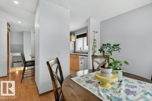 Dining area featuring hardwood floors and a view into the kitchen with light wood cabinetry - 2655 89 Street, Edmonton, AB - Indoor Photo Showing Dining Room