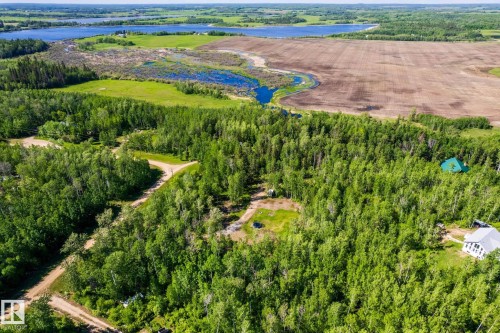 Expansive acreage featuring mature trees, a cleared building site, and a gravel drive - 17 56110 Rge Road 13, Rural Lac Ste. Anne County, AB 