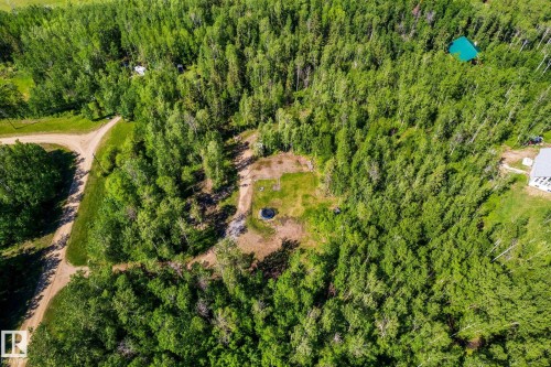 Heavily treed property featuring a cleared building site, existing gravel roads, and a circular ground feature - 17 56110 Rge Road 13, Rural Lac Ste. Anne County, AB 