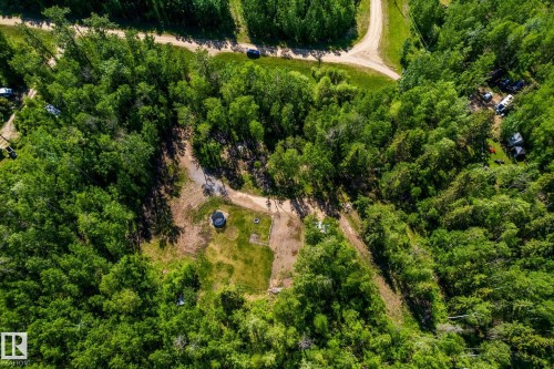 Wooded landscape featuring a cleared building site, a circular structure, and a dirt road network - 17 56110 Rge Road 13, Rural Lac Ste. Anne County, AB 