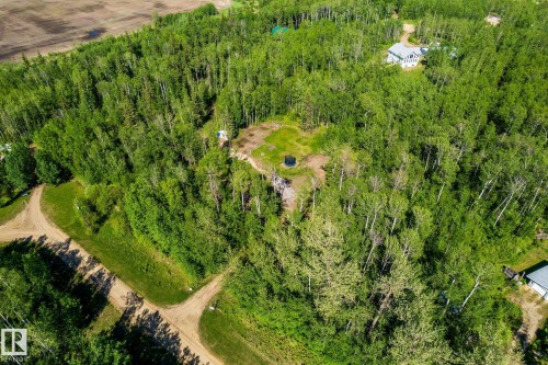 Expansive wooded landscape featuring a cleared circular area, multiple dirt paths, and distant structures - 17 56110 Rge Road 13, Rural Lac Ste. Anne County, AB 