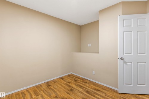 This room features wood-look flooring and light-colored walls - 1233 Ormsby Lane, Edmonton, AB - Indoor Photo Showing Other Room