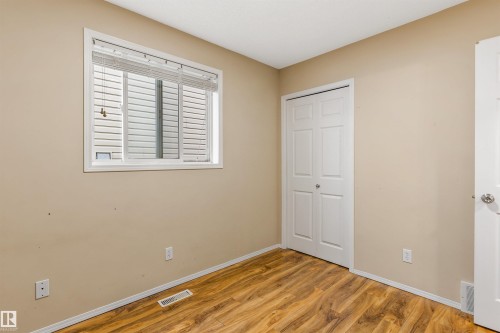 This room features wood-look flooring and a window with blinds - 1233 Ormsby Lane, Edmonton, AB - Indoor Photo Showing Other Room