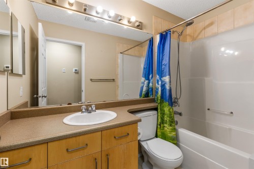 Bathroom featuring a vanity with an integrated sink, a large mirror, and overhead lighting - 1233 Ormsby Lane, Edmonton, AB - Indoor Photo Showing Bathroom