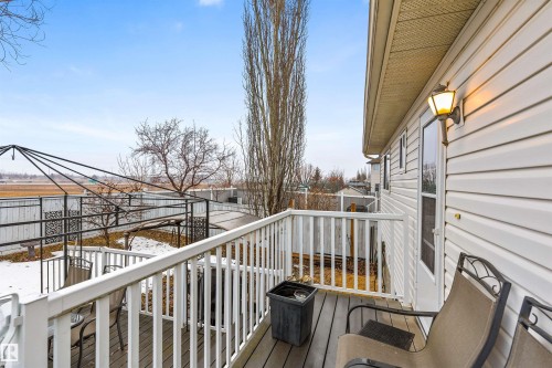 This property features a private deck with a white railing, providing direct access to the outdoor space - 1233 Ormsby Lane, Edmonton, AB - Outdoor With Deck Patio Veranda With Exterior