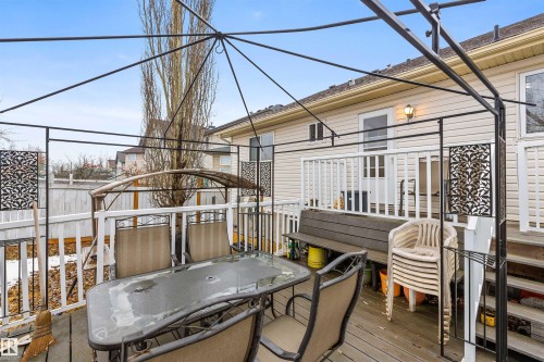 The property features an outdoor deck with a metal gazebo frame, painted wooden railings, and siding - 1233 Ormsby Lane, Edmonton, AB - Outdoor With Deck Patio Veranda With Exterior