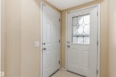 The property features a white door with decorative glass inserts, complemented by another white door and light-colored walls - 1233 Ormsby Lane, Edmonton, AB  - Indoor Photo Showing Other Room 