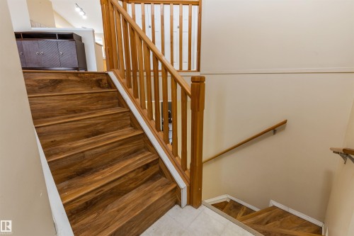 Staircase featuring hardwood steps and a natural wood handrail - 1233 Ormsby Lane, Edmonton, AB - Indoor Photo Showing Other Room