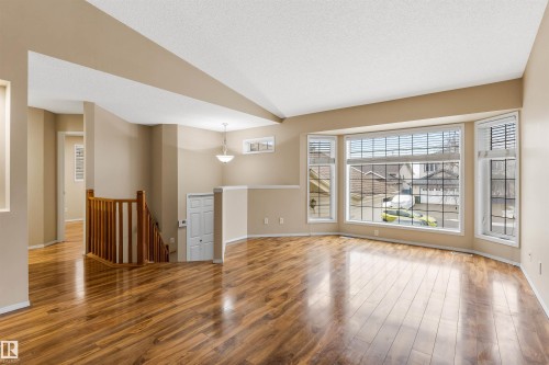 This inviting living space features gleaming hardwood floors and a large bay window, providing ample natural light - 1233 Ormsby Lane, Edmonton, AB - Indoor Photo Showing Other Room