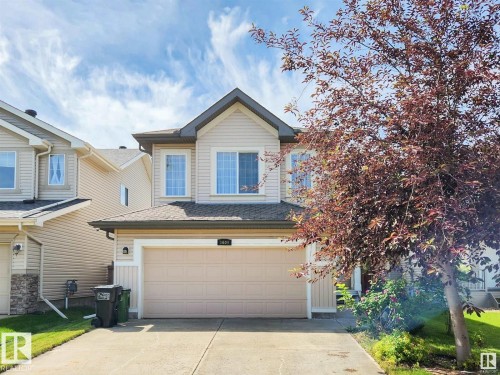 The property features a two-story exterior with light-colored siding and a contrasting roof - 1609 Hodgson Crest, Edmonton, AB - Outdoor