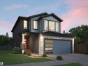 Contemporary property with a striking blue and gray exterior, featuring a prominent garage with decorative glass panels - 1729 Crossbill Loop, Edmonton, AB  - Outdoor 