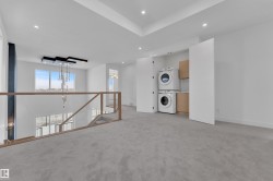 This open area features soft grey carpeting and recessed lighting - 