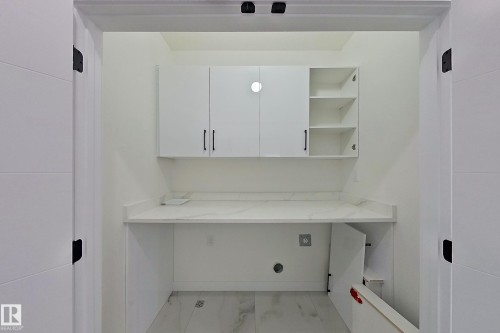 This utility space features a white countertop and white cabinetry, including open shelving - 8425 Mayday Link Link, Edmonton, AB - Indoor