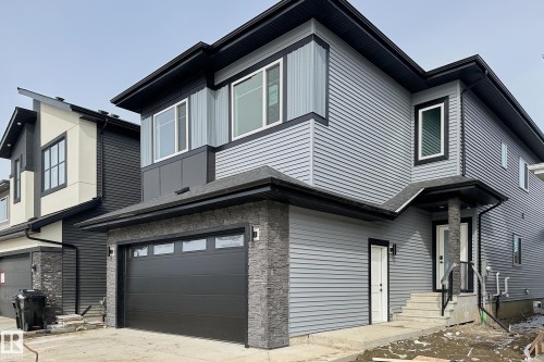 The property features a modern exterior with gray siding and black trim - 8425 Mayday Link Link, Edmonton, AB - Outdoor