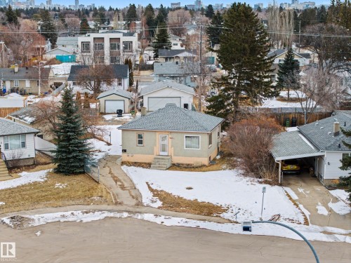 The property features a main house with a light-colored exterior and a covered front entrance - 9409 154 Street, Edmonton, AB - Outdoor