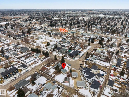 Aerial view of the neighborhood featuring residential streets, houses with various roof styles, and evergreen trees - 9409 154 Street, Edmonton, AB - Outdoor With View