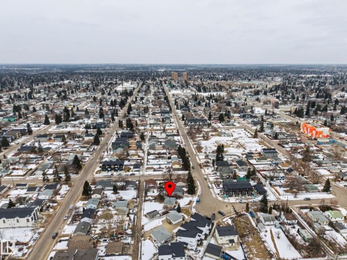 Aerial view of the surrounding residential neighborhood with tree-lined streets and scattered commercial buildings in the distance - 9409 154 Street, Edmonton, AB - Outdoor With View