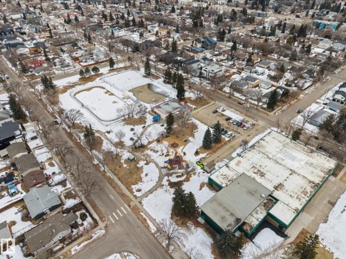 The property is situated within a residential neighborhood featuring established trees and a community park with recreational facilities including a playground and two snow-covered rinks - 9409 154 Street, Edmonton, AB - Outdoor With View
