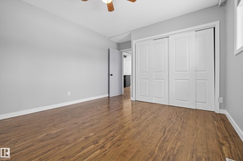 This room features wood-look flooring and light grey walls - 3613 113 Avenue, Edmonton, AB - Indoor Photo Showing Other Room