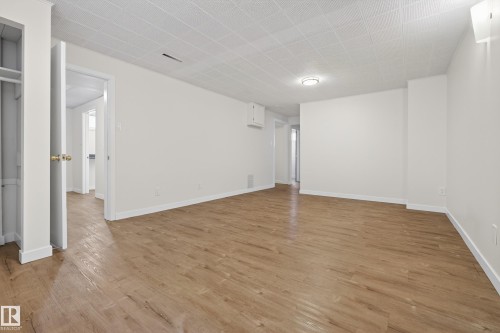 This spacious room features light wood flooring and white walls, creating a bright and airy atmosphere - 3613 113 Avenue, Edmonton, AB - Indoor Photo Showing Other Room