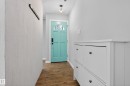Entryway featuring a brightly colored door with frosted glass panes, wood-look flooring, and a contemporary ceiling light fixture - 3613 113 Avenue, Edmonton, AB  - Indoor Photo Showing Other Room 