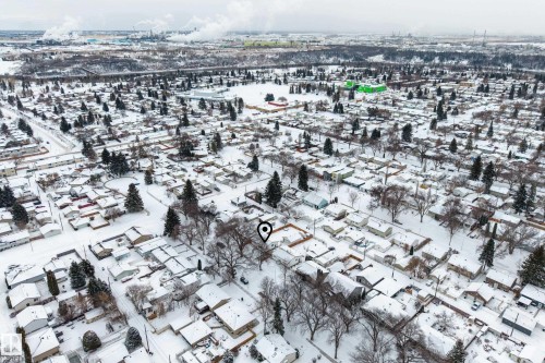 Aerial view of the surrounding neighborhood, featuring numerous residential properties with snow-covered rooftops and mature trees - 3613 113 Avenue, Edmonton, AB - Outdoor With View