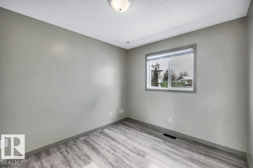 This room features light grey walls and light-toned, wood-look flooring - 902 Graham Wynd, Edmonton, AB - Indoor Photo Showing Other Room