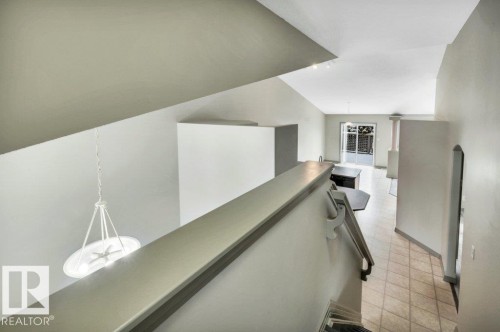The property features vaulted ceilings, light-colored walls, and tiled flooring - 902 Graham Wynd, Edmonton, AB - Indoor Photo Showing Other Room