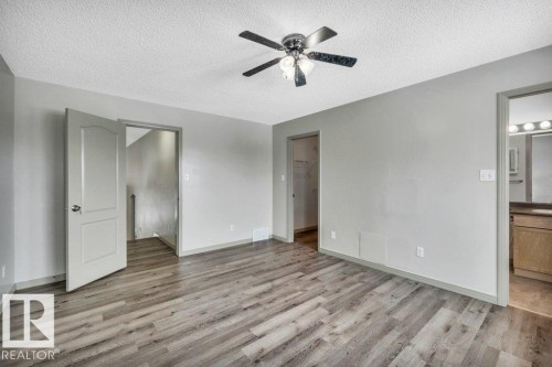 This inviting room features wood-look flooring, light grey walls, and a ceiling fan with integrated lighting - 902 Graham Wynd, Edmonton, AB - Indoor Photo Showing Other Room