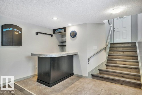 Recreation area featuring a built-in bar with a countertop, recessed lighting, and tile flooring - 902 Graham Wynd, Edmonton, AB - Indoor Photo Showing Other Room