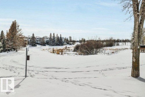 The property offers views of a snow-covered landscape with distant residential buildings and evergreen trees - 902 Graham Wynd, Edmonton, AB - Outdoor With View