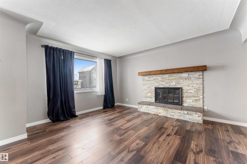 7316 82 Street, Edmonton, AB - Indoor Photo Showing Living Room With Fireplace