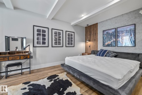 This room features wood-style flooring, a textured accent wall, and recessed lighting - 314 10309 107 Street, Edmonton, AB - Indoor Photo Showing Bedroom