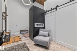 Entryway with light gray tile flooring, a geometric ceiling light fixture, and a white barn door - 