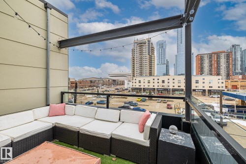 The property features an outdoor patio area with a city skyline view - 314 10309 107 Street, Edmonton, AB - Outdoor With Exterior