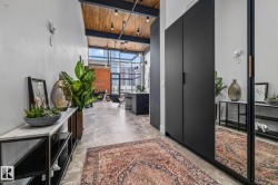 The property features an entryway with high ceilings, exposed wooden beams, and track lighting - 
