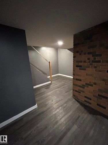 Finished below grade area featuring stairway and dark wood finished floors - 15016 80 Street, Edmonton, AB - Indoor Photo Showing Other Room