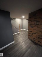 Finished below grade area featuring stairway and dark wood finished floors - 