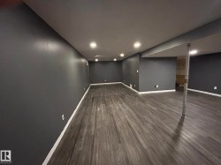 Finished basement with dark wood-type flooring and recessed lighting - 