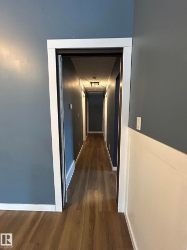 Hallway with dark wood finished floors and baseboards - 15016 80 Street, Edmonton, AB - Indoor Photo Showing Other Room