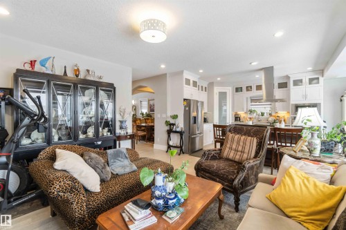 The open-concept living area features recessed lighting and a decorative ceiling light fixture - 4 Lakeshore Cove, Beaumont, AB 