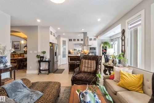 The property features an open concept living area with light-colored flooring and recessed lighting - 4 Lakeshore Cove, Beaumont, AB 