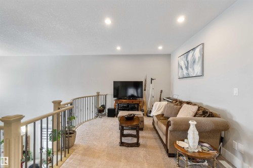 Living area featuring light-colored walls, recessed lighting, and carpeting - 4 Lakeshore Cove, Beaumont, AB 